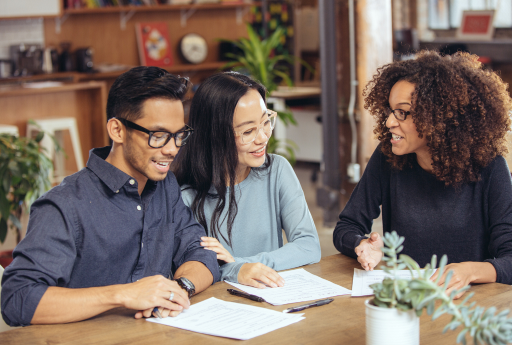 homeowner couple with title service agent checking house title
