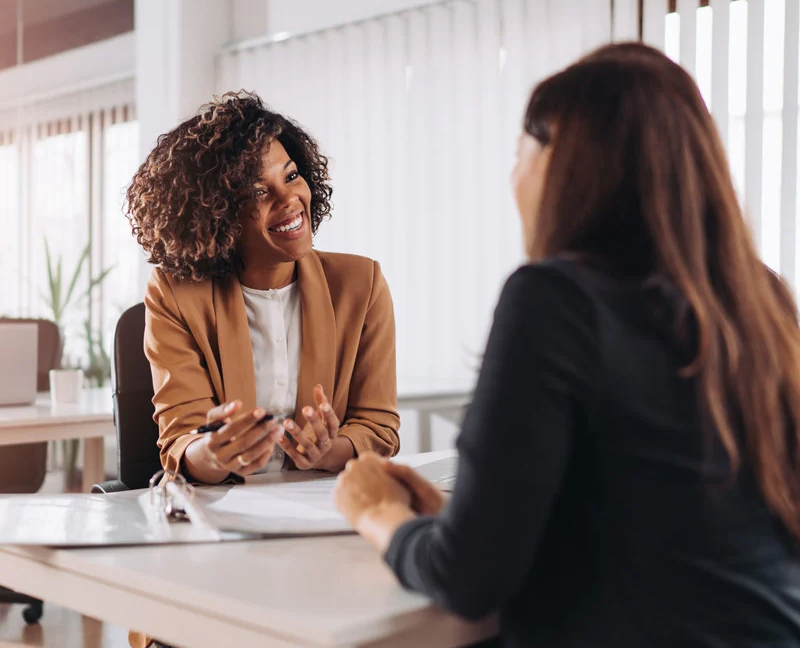 black-woman-settlement-agent-talking-to-woman-homebuyer