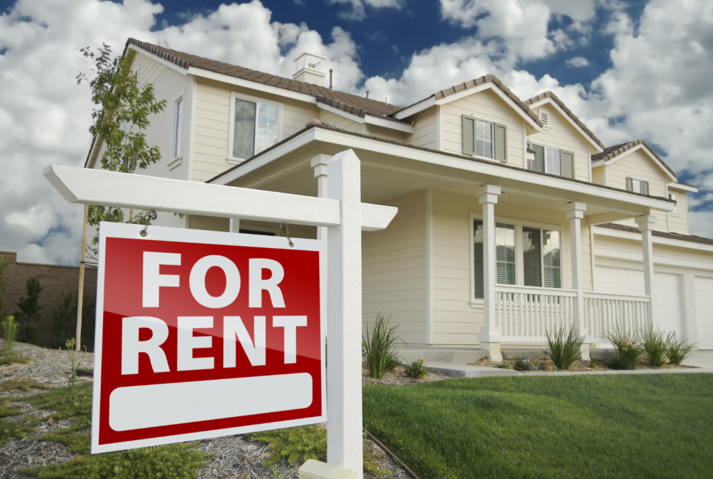 for rent sign in front of white house apartment