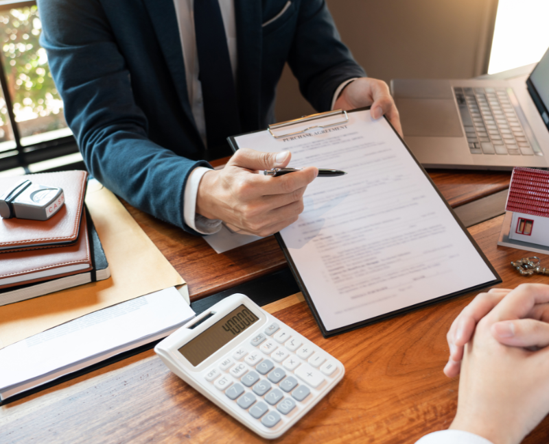 agent holding purchase agreement and pen