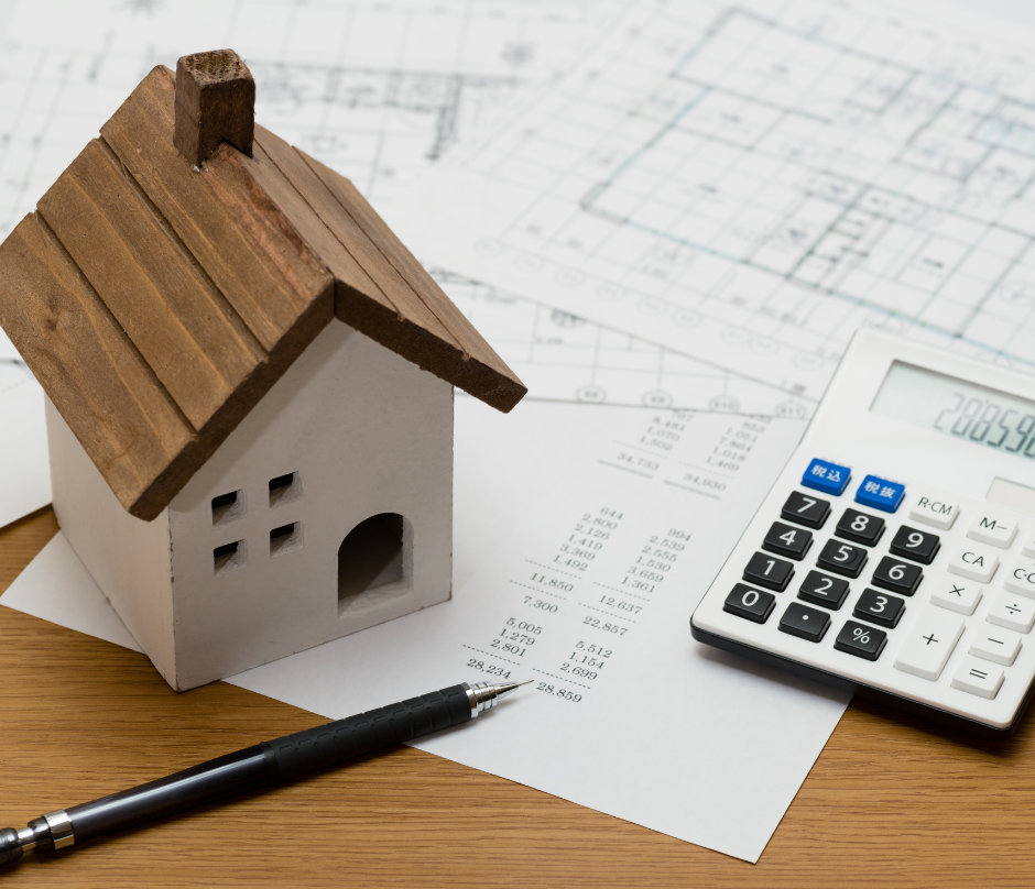mini house with calculator and a pen