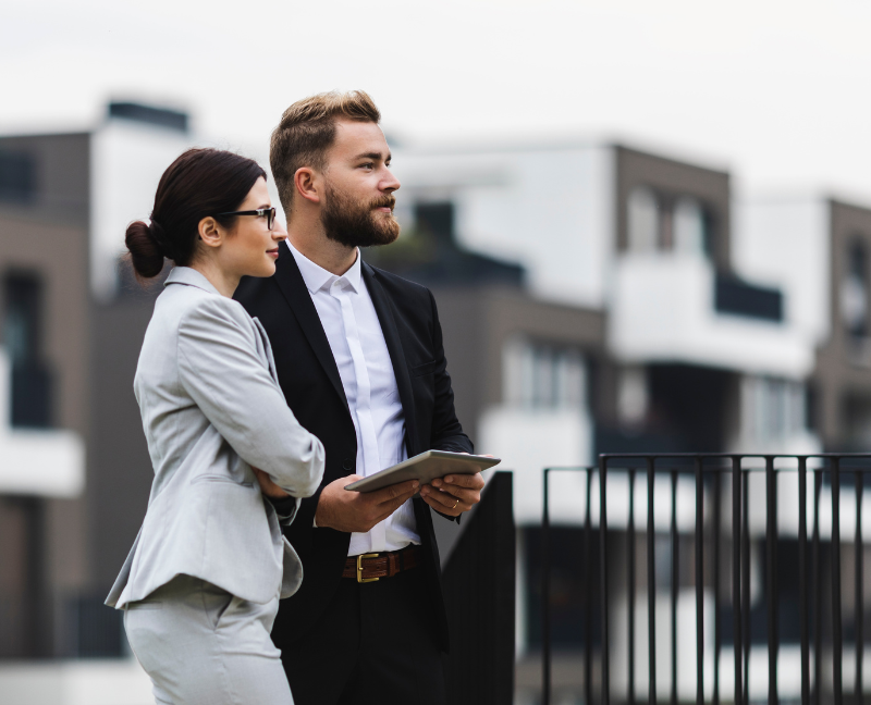 two real estate agents looking forward