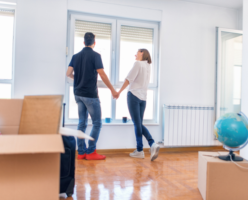 couple holding hands in new home