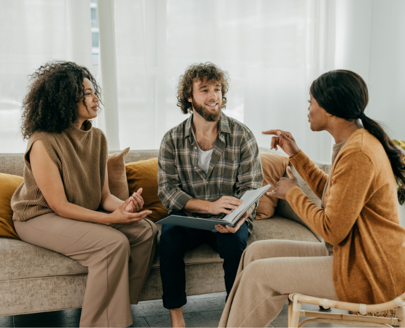 real estate agent talking to first time home buyers