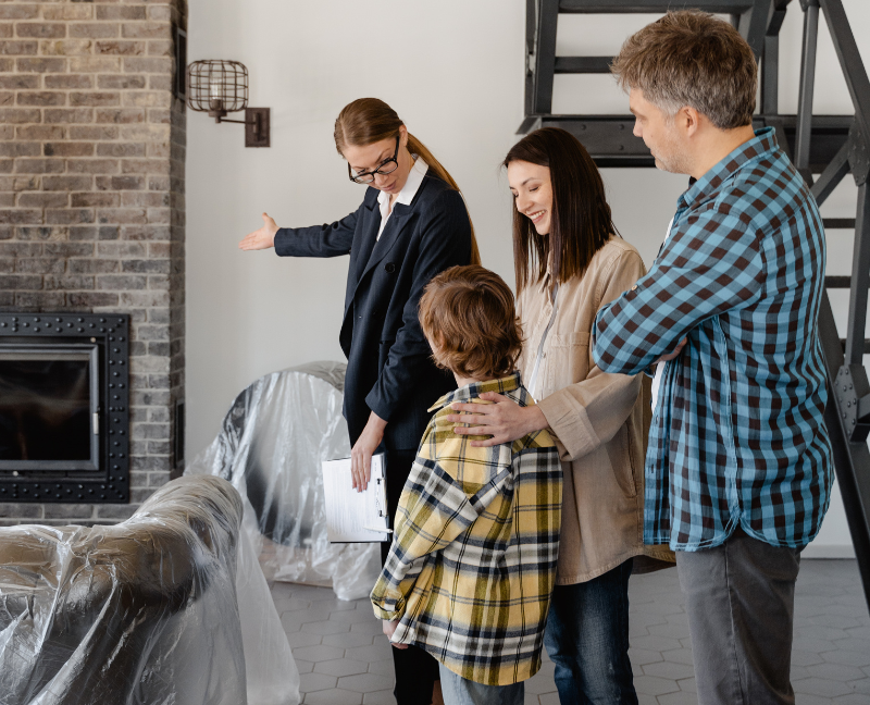 real estate agent showing family new home