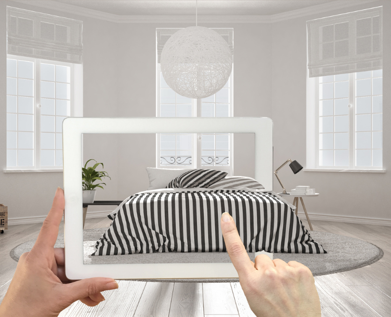 hand holding tablet of house