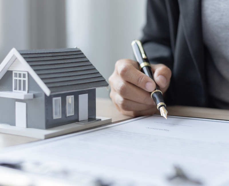 home insurance seller holding a pen