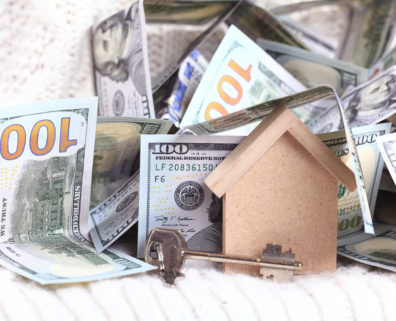 money and wooden construction house and key