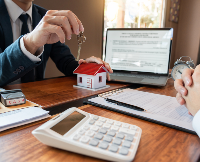 real estate broker holding key for closing transaction with buyer