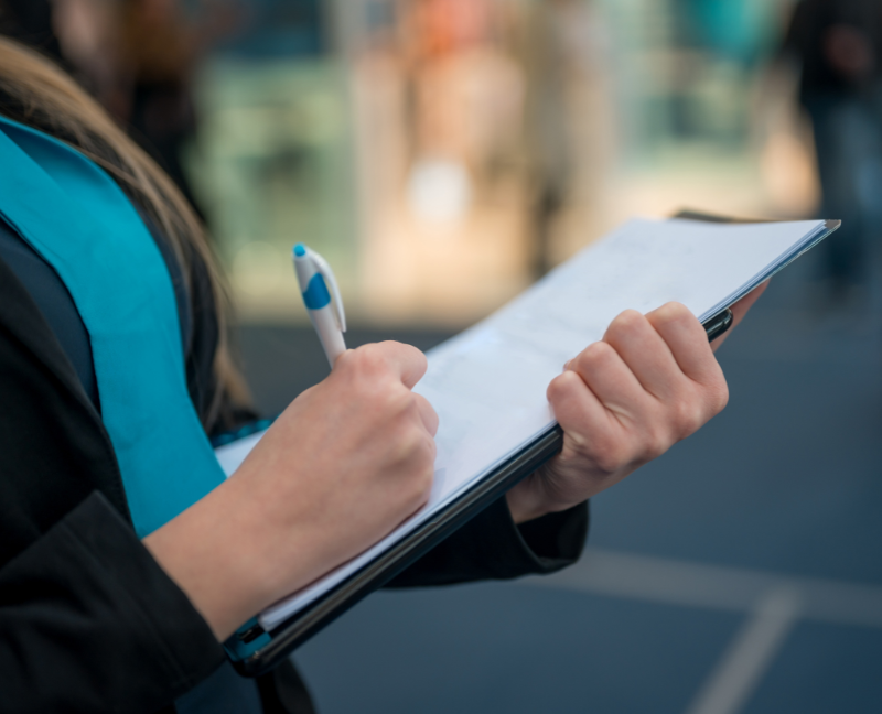 woman holding pen and checklist