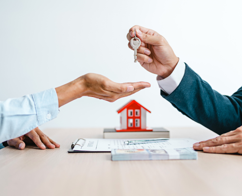 realtor giving key to homebuyer