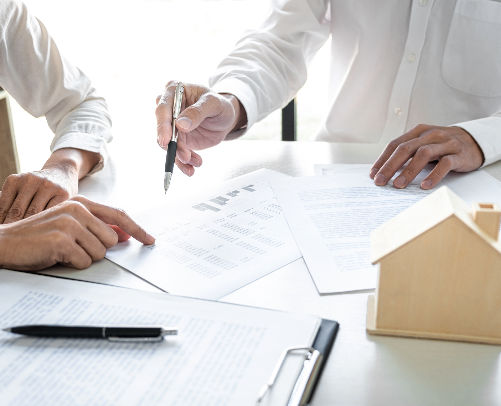 real estate agent showing some important papers to a client
