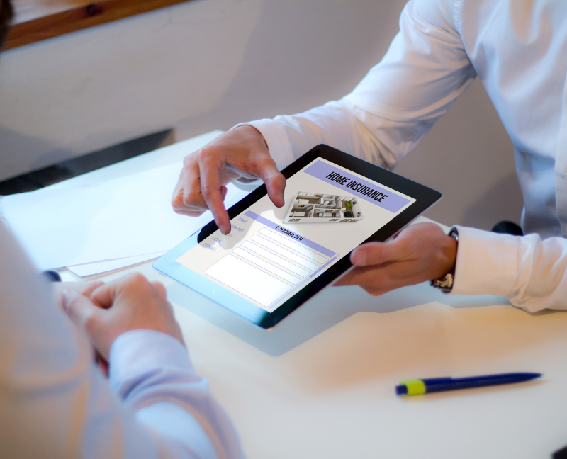agent showing home insurance on ipad