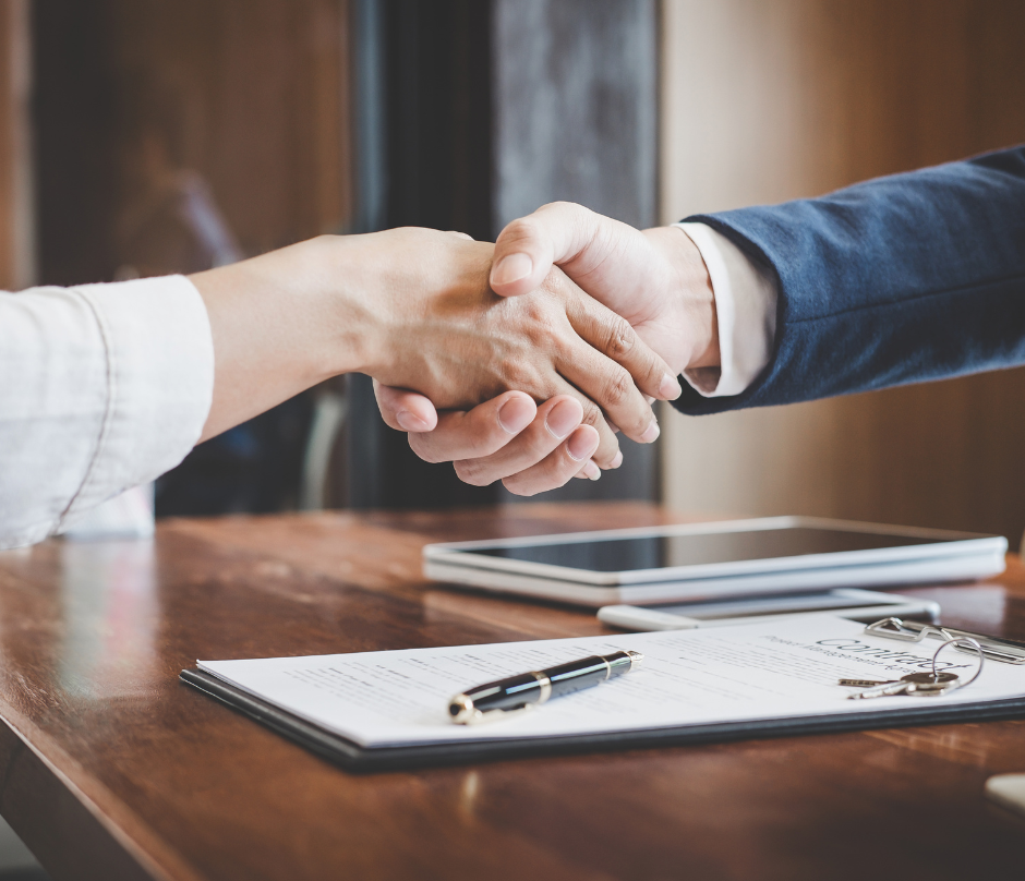 title insurance agent and client shaking hands