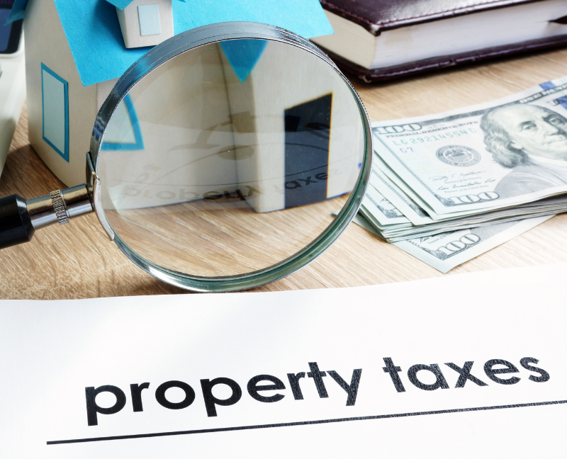 property taxes files with magnifying glass