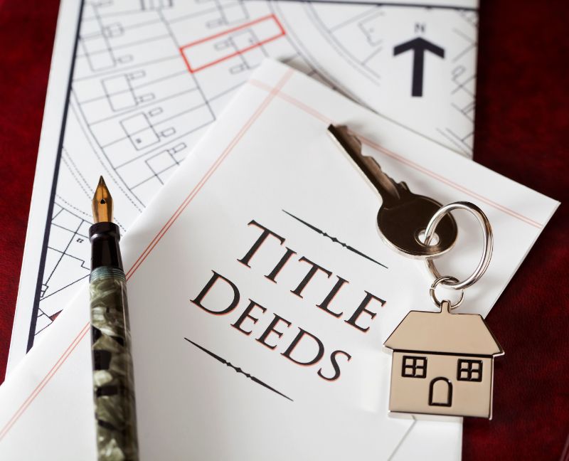 title deed paper with pen and house key